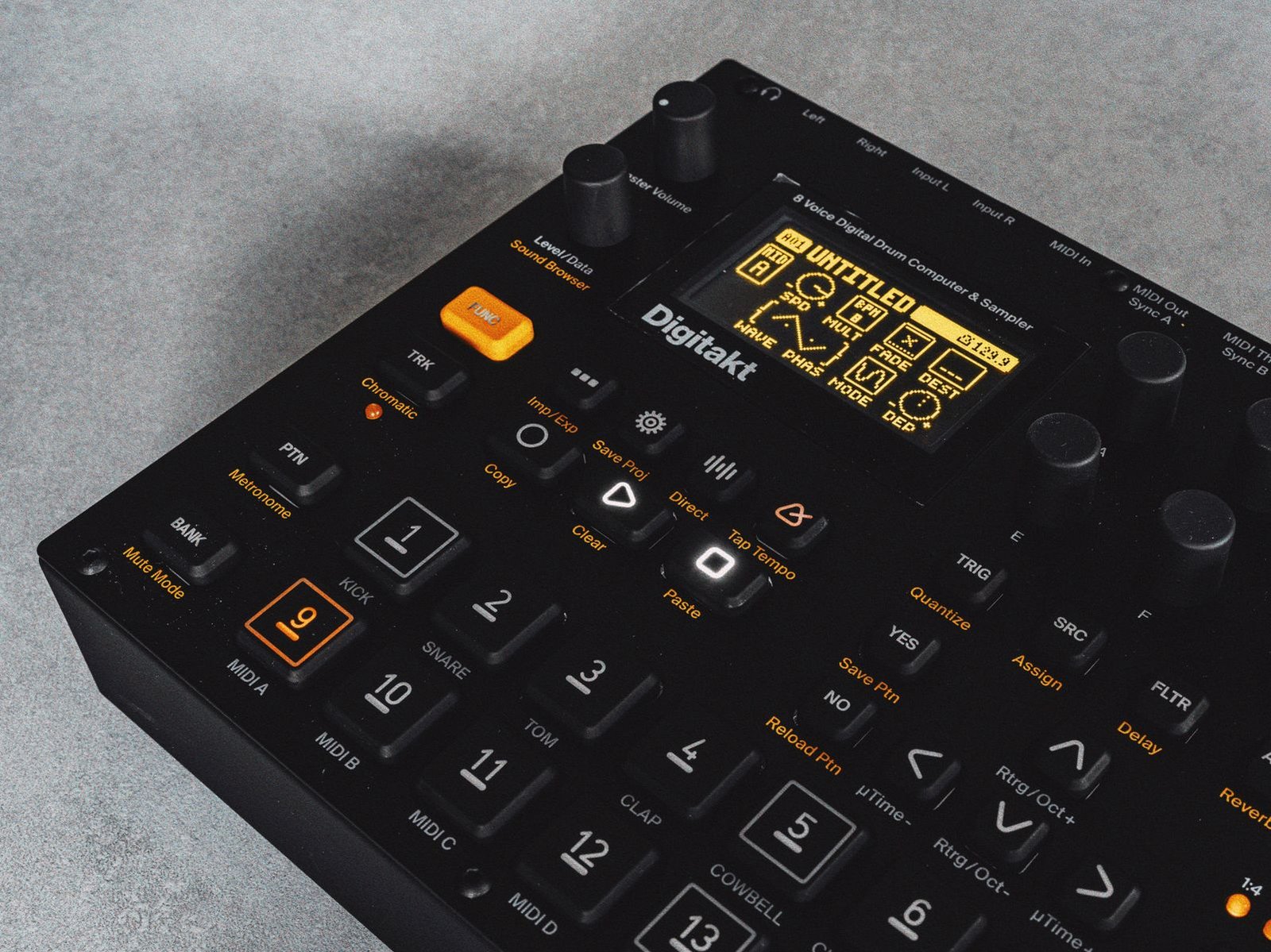 Close-up of an Elektron Digitakt sampler and drum machine with an illuminated display.