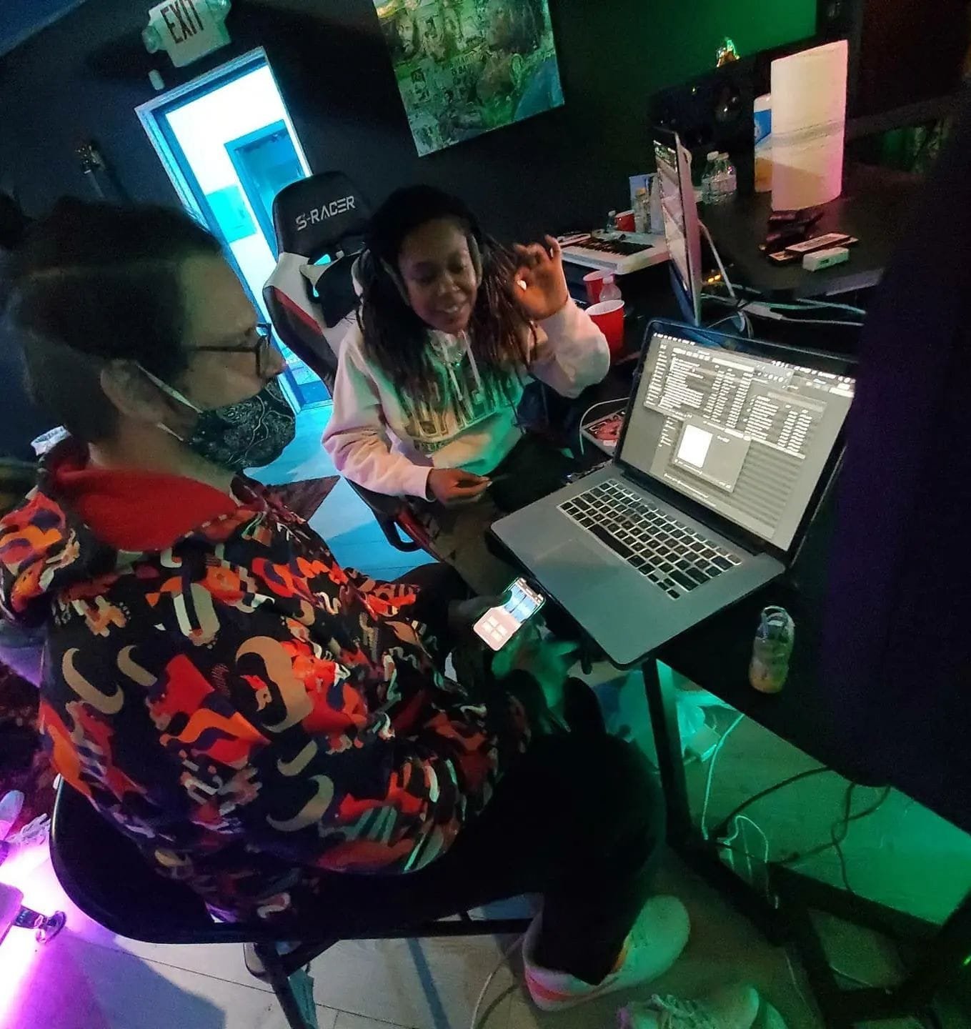 Two Creative Space participants collaborating at a studio workstation